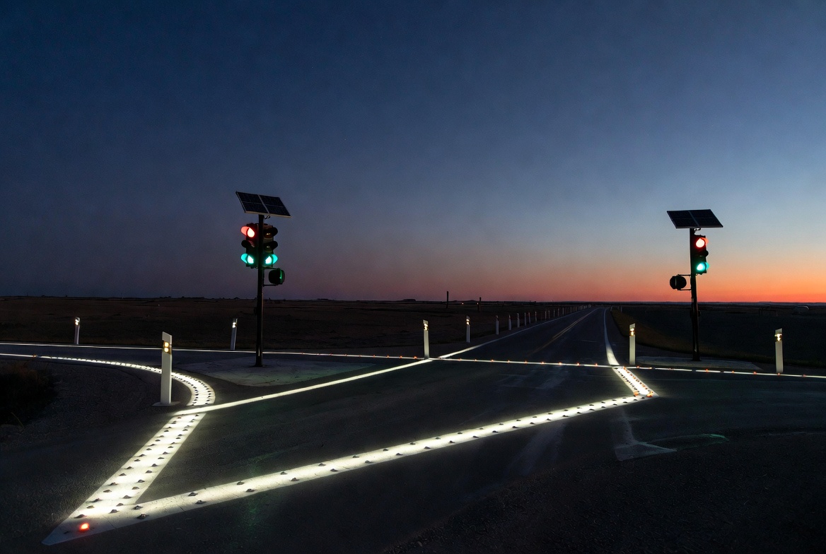 Solar Traffic Lights And Road Markers At Rural Intersection.jpg